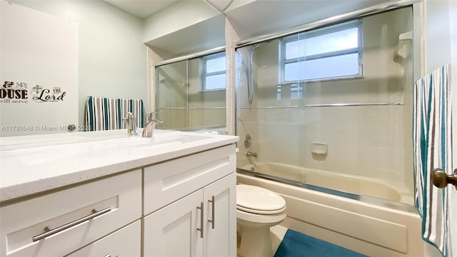 full bathroom with combined bath / shower with glass door, toilet, and vanity