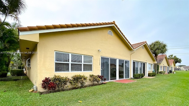 rear view of property featuring a yard