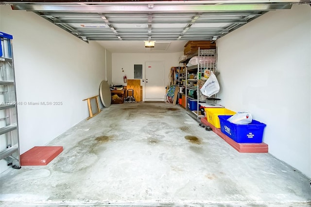 garage featuring a garage door opener and electric panel