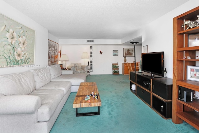 carpeted living room featuring a textured ceiling