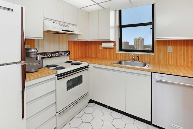 kitchen featuring sink, white appliances, and white cabinets