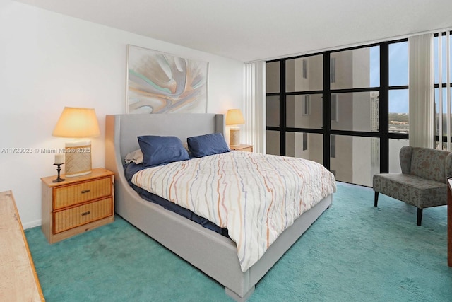 bedroom featuring a wall of windows and carpet flooring