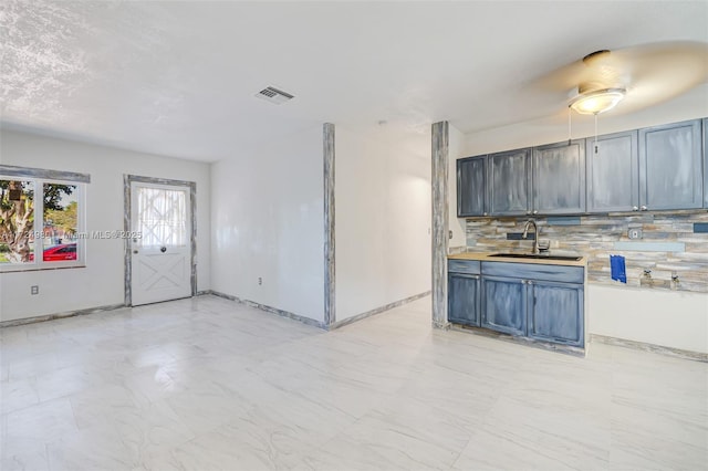 kitchen featuring decorative backsplash and sink