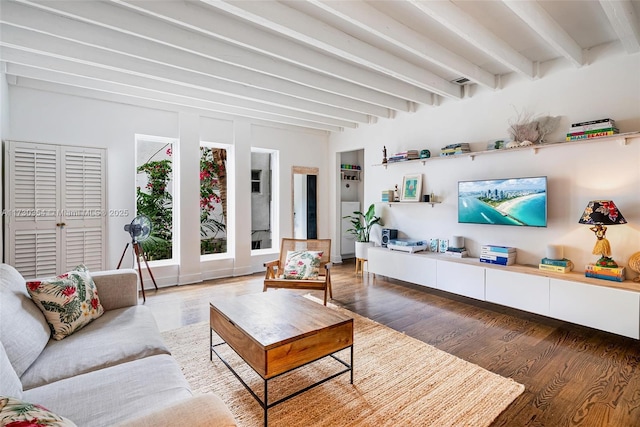 living room featuring beamed ceiling and wood-type flooring