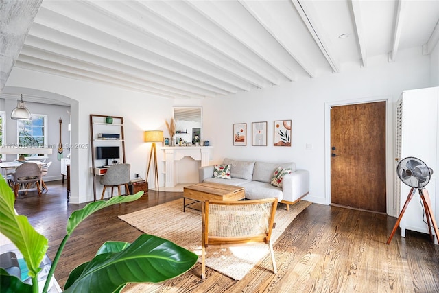 living room featuring beam ceiling and dark hardwood / wood-style floors