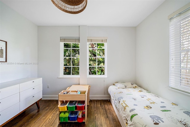 bedroom with dark wood-type flooring