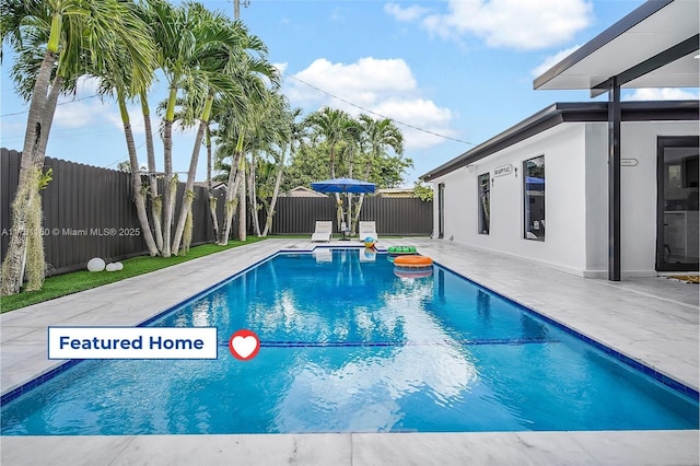 view of pool with a fenced in pool, a patio, and a fenced backyard