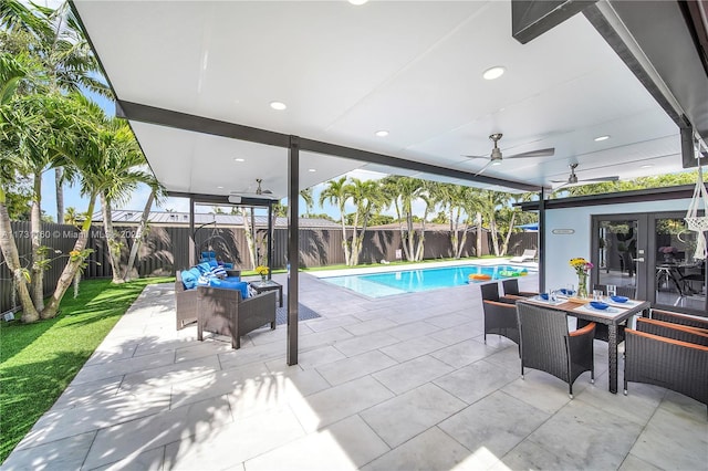 view of swimming pool with ceiling fan and a patio area