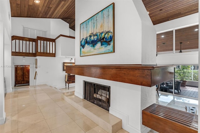 interior space featuring high vaulted ceiling, light tile patterned floors, a fireplace, and wooden ceiling