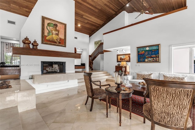 living room featuring wood ceiling, ceiling fan, and high vaulted ceiling