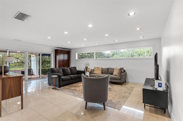 living room with light tile patterned flooring and a healthy amount of sunlight