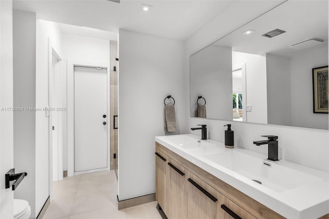 bathroom featuring tile patterned flooring, vanity, an enclosed shower, and toilet