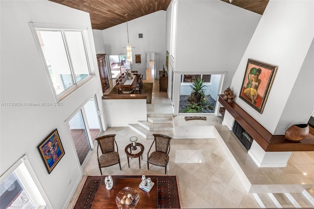 living room with wood ceiling and high vaulted ceiling