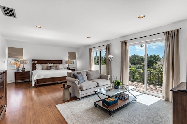 bedroom featuring wood-type flooring and access to exterior