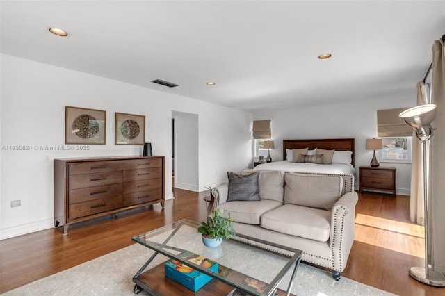 bedroom with dark hardwood / wood-style floors