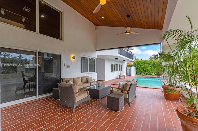 view of patio featuring a fenced in pool, outdoor lounge area, and ceiling fan