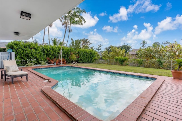 view of pool featuring a yard and a patio