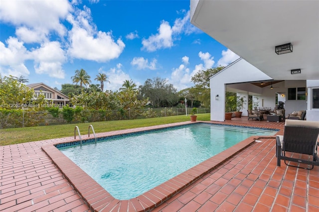 view of swimming pool featuring a yard, ceiling fan, and a patio area