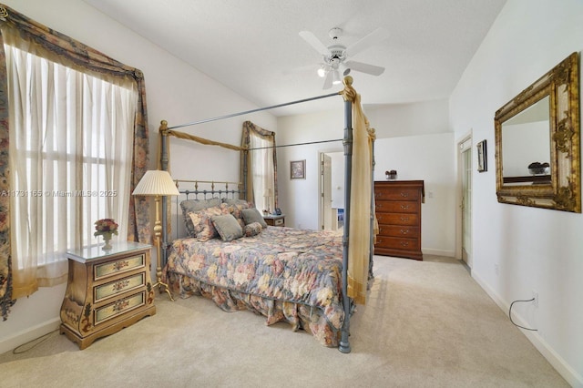 bedroom with ceiling fan and light carpet