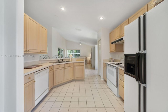 kitchen featuring white appliances, light brown cabinets, sink, kitchen peninsula, and vaulted ceiling