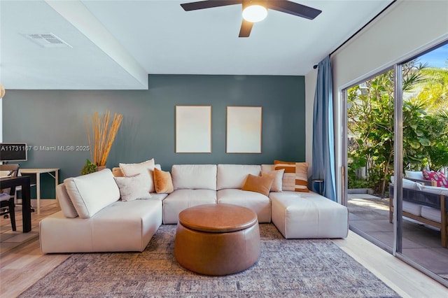 living room with hardwood / wood-style floors and ceiling fan