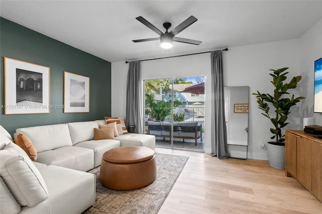 living room with ceiling fan and light wood-type flooring