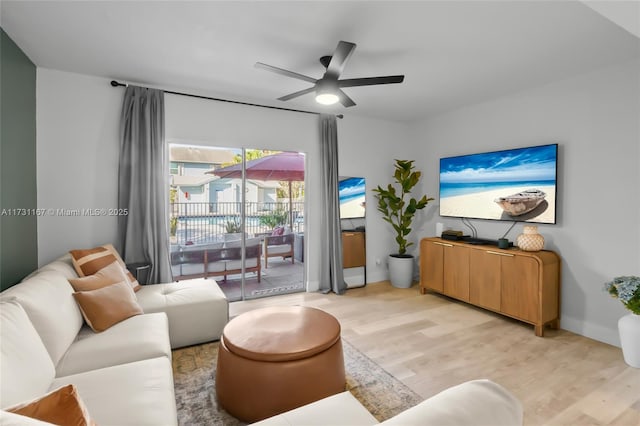 living room with ceiling fan and light wood-type flooring