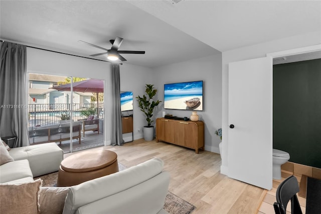 living room with light hardwood / wood-style floors and ceiling fan