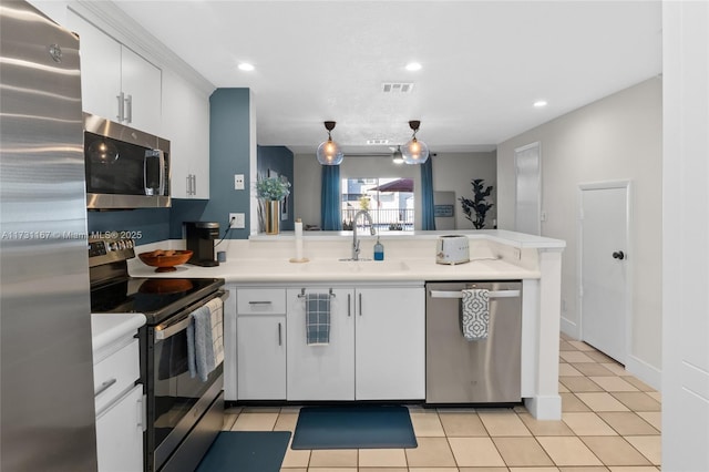 kitchen with pendant lighting, sink, stainless steel appliances, white cabinets, and kitchen peninsula