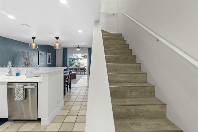 stairway featuring tile patterned flooring and ceiling fan