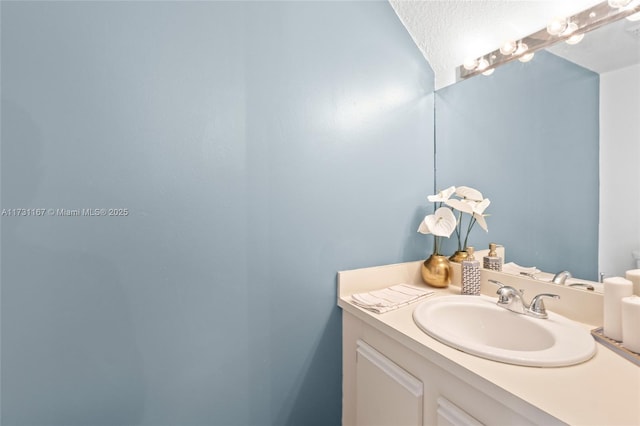 bathroom with vanity and a textured ceiling