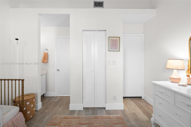 unfurnished bedroom with light hardwood / wood-style floors and a closet