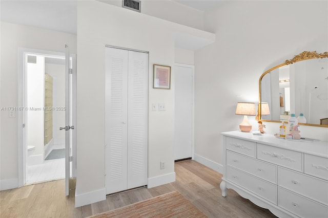 bedroom featuring light hardwood / wood-style floors and a closet