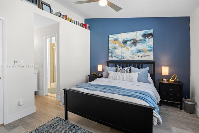 bedroom featuring hardwood / wood-style floors, lofted ceiling, connected bathroom, and ceiling fan