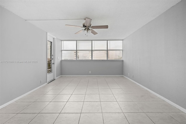 tiled spare room with ceiling fan and a textured ceiling