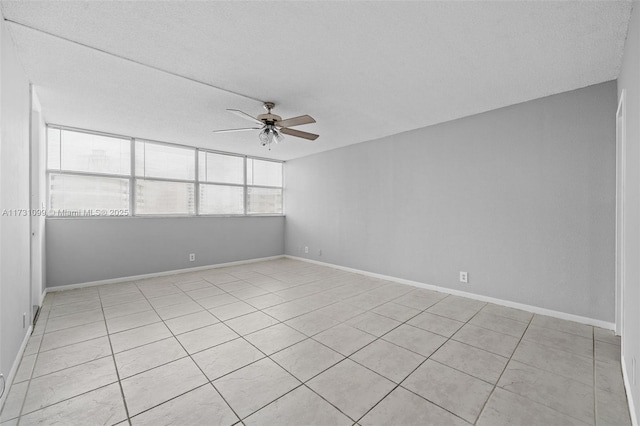 spare room with light tile patterned floors and ceiling fan