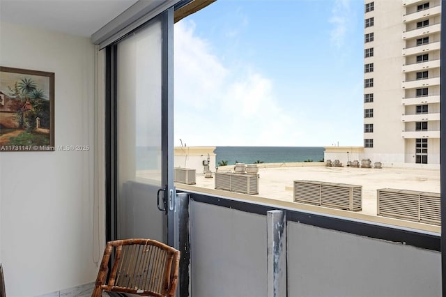 balcony with a water view and a beach view