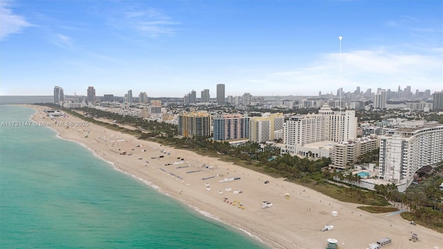 drone / aerial view featuring a beach view and a water view