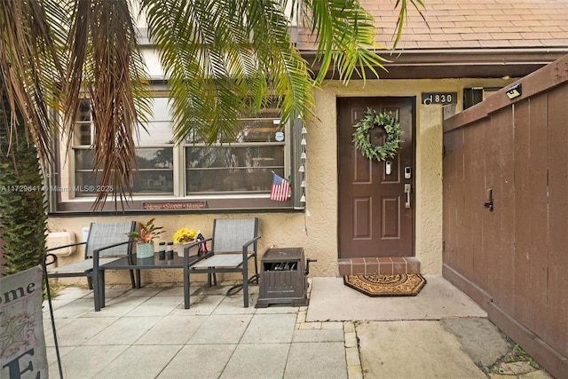 doorway to property with a patio area