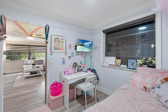 bedroom featuring ornamental molding and hardwood / wood-style floors