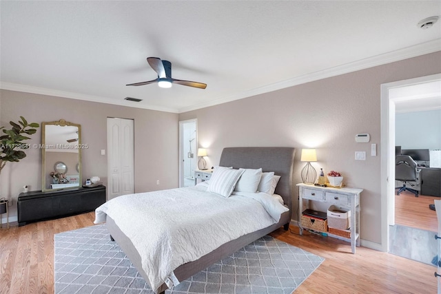 bedroom featuring ceiling fan, ornamental molding, and hardwood / wood-style floors