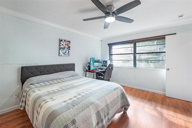 bedroom featuring ceiling fan, wood-type flooring, and ornamental molding