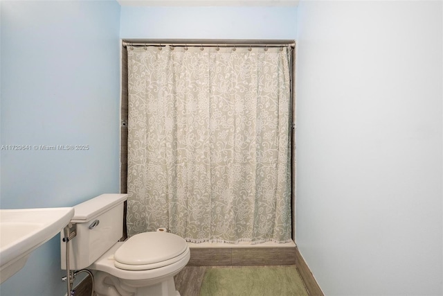 bathroom with toilet and tile patterned flooring