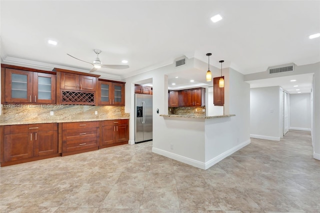 kitchen with crown molding, backsplash, light stone countertops, stainless steel fridge with ice dispenser, and decorative light fixtures