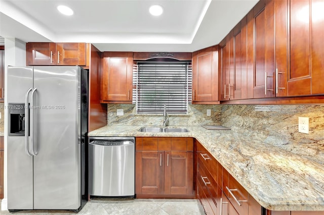 kitchen featuring sink, backsplash, light tile patterned floors, stainless steel appliances, and light stone countertops