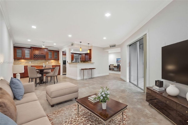 living room featuring crown molding and ceiling fan