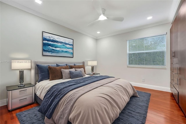 bedroom featuring crown molding, ceiling fan, and dark hardwood / wood-style flooring