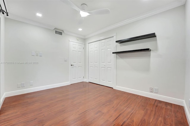 spare room featuring hardwood / wood-style flooring, ornamental molding, and ceiling fan