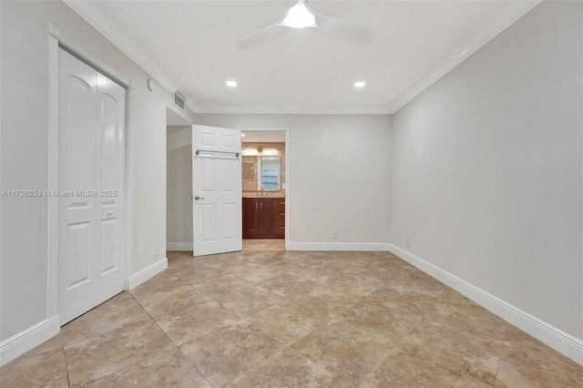 unfurnished bedroom with ornamental molding, a closet, ceiling fan, and ensuite bathroom