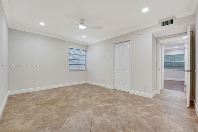 unfurnished bedroom with crown molding, ceiling fan, a closet, and light tile patterned floors